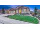 Charming front exterior with a three-car garage, manicured lawn, and stone accents at 3242 Waterfront Dr, Monument, CO 80132