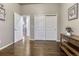 Hallway with hardwood floors, white trim, and multiple entryways at 3242 Waterfront Dr, Monument, CO 80132