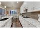 Charming kitchen with granite counters, stainless appliances and modern backsplash at 3242 Waterfront Dr, Monument, CO 80132