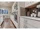 Gourmet kitchen featuring stainless steel appliances, white cabinetry, and hardwood floors at 3242 Waterfront Dr, Monument, CO 80132