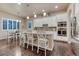 Bright kitchen featuring a large island, white cabinets, granite countertops, and stainless steel appliances at 3242 Waterfront Dr, Monument, CO 80132