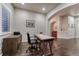 Well-lit home office with dark wood floors, shutters, and desk at 3242 Waterfront Dr, Monument, CO 80132