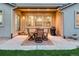 Covered patio with outdoor dining set and grill, perfect for entertaining at 3242 Waterfront Dr, Monument, CO 80132