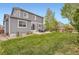 Spacious, grassy backyard with a patio area and a wooden fence offering privacy at 14110 Greenfield Loop, Parker, CO 80134