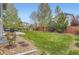 Lush backyard with well-maintained lawn, garden beds, a patio, and a wood fence at 14110 Greenfield Loop, Parker, CO 80134