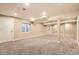 Unfinished basement with neutral carpet, recessed lighting, and exposed ceiling beams, ready for customization at 14110 Greenfield Loop, Parker, CO 80134