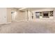 Expansive finished basement featuring carpet, built-in shelving, and stylish support beams at 14110 Greenfield Loop, Parker, CO 80134