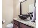 Elegant half bathroom with granite countertop, vessel sink, and decorative faucet at 14110 Greenfield Loop, Parker, CO 80134