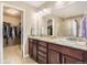 This bathroom boasts double sinks with granite countertops and a walk-in closet at 14110 Greenfield Loop, Parker, CO 80134