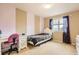 Cozy bedroom with striped accent wall, white furniture, and a bright window at 14110 Greenfield Loop, Parker, CO 80134