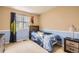 Neutral-toned bedroom with blue wainscoting, a large window, and plush carpet at 14110 Greenfield Loop, Parker, CO 80134