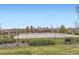Well-maintained community pool featuring an outdoor lounge, grassy area, and mature trees at 14110 Greenfield Loop, Parker, CO 80134