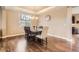 Elegant dining room with hardwood floors, coffered ceiling, large window, and chandelier lighting at 14110 Greenfield Loop, Parker, CO 80134