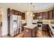 Updated kitchen featuring stainless steel appliances, granite counters, island, tile backsplash and hardwood flooring at 14110 Greenfield Loop, Parker, CO 80134