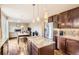 Open kitchen layout flowing into the dining and living area, hardwood floors, granite counters and island at 14110 Greenfield Loop, Parker, CO 80134