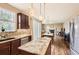 Bright kitchen with stainless appliances, granite counters, island, tile backsplash, hardwood flooring and a window at 14110 Greenfield Loop, Parker, CO 80134