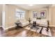Inviting living room features hardwood floors, neutral paint and ample natural light and a large area rug at 14110 Greenfield Loop, Parker, CO 80134