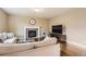 Comfortable living room featuring a stone fireplace, hardwood floors, and neutral color palette at 14110 Greenfield Loop, Parker, CO 80134