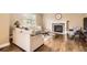 Bright living room with fireplace, large windows, hardwood floors, neutral paint and modern furnishings at 14110 Greenfield Loop, Parker, CO 80134