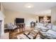 Open living room showcasing hardwood floors, stone fireplace, neutral paint, modern furniture and bright lighting at 14110 Greenfield Loop, Parker, CO 80134