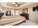 Comfortable main bedroom featuring a ceiling fan, tray ceiling, and wood furniture at 14110 Greenfield Loop, Parker, CO 80134