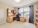Bright office featuring a large desk, built-in storage, a window with blinds, and neutral carpet at 14110 Greenfield Loop, Parker, CO 80134
