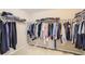 Bright walk-in closet with neutral carpet and white wire shelving for optimal storage and organization at 14110 Greenfield Loop, Parker, CO 80134
