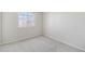 This simple bedroom features neutral tones and a sunlit window at 1838 Wilson Cir, Erie, CO 80516