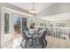 Elegant dining area with large windows, access to the outdoor patio, and modern decor at 1838 Wilson Cir, Erie, CO 80516