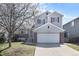 Charming two-story home with red window shutters, a well-kept lawn, and a two car garage at 1838 Wilson Cir, Erie, CO 80516