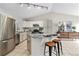 Spacious kitchen featuring stainless steel appliances, granite countertops, an island, and modern lighting at 1838 Wilson Cir, Erie, CO 80516