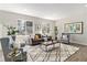 Inviting living room featuring a cozy seating arrangement, hardwood floors, and plenty of natural light at 1838 Wilson Cir, Erie, CO 80516