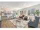 Bright and spacious living room with hard wood floors, large windows, and modern furniture at 1838 Wilson Cir, Erie, CO 80516