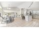 Open-concept living area with a kitchen, dining space, bar seating, and modern tile flooring at 1838 Wilson Cir, Erie, CO 80516