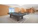 Finished basement featuring a pool table, foosball table, and sliding glass door at 2130 Frontier Ln, Franktown, CO 80116
