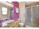 Bathroom featuring a shower with sliding glass doors and a pink tiled countertop and trim at 2130 Frontier Ln, Franktown, CO 80116