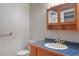 Bright bathroom featuring tile countertops and a cabinet for toiletries at 2130 Frontier Ln, Franktown, CO 80116