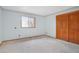 Bright bedroom featuring a large window providing natural light and a spacious closet at 2130 Frontier Ln, Franktown, CO 80116