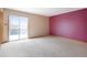 Bedroom with a sliding glass door leading to a balcony, a brightly painted accent wall at 2130 Frontier Ln, Franktown, CO 80116