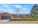 Charming red brick home featuring an attached garage and a well-manicured front yard at 2130 Frontier Ln, Franktown, CO 80116