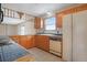Traditional-style kitchen featuring wood cabinets, tile countertops, and bright natural light from the window at 2130 Frontier Ln, Franktown, CO 80116