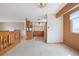 Bright living area with wooden railing overlooking dining and kitchen areas at 2130 Frontier Ln, Franktown, CO 80116