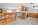 Bright kitchen with wood cabinetry and white tile flooring at 2130 Frontier Ln, Franktown, CO 80116