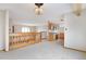 Bright living area with wooden railing overlooking dining and kitchen areas at 2130 Frontier Ln, Franktown, CO 80116