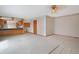 Spacious living room featuring an open concept design with tile flooring and a view into the kitchen at 2130 Frontier Ln, Franktown, CO 80116