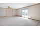 Bright living room boasting sliding glass doors, carpeted floors, and ceiling fan at 2130 Frontier Ln, Franktown, CO 80116