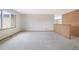 Well-lit living room featuring neutral walls, white carpets, and a large window at 2130 Frontier Ln, Franktown, CO 80116