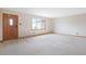 Bright living room with white carpet and a large window, creating a welcoming space at 2130 Frontier Ln, Franktown, CO 80116