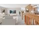 Cozy living room with modern decor, seamlessly connected to the kitchen with a view of the outdoors at 2130 Frontier Ln, Franktown, CO 80116