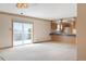 Bright and airy living room featuring sliding glass doors that lead to outdoor views and cozy carpet at 2130 Frontier Ln, Franktown, CO 80116
